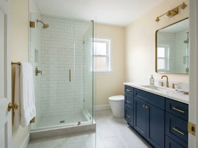 Illustration: remodeled bathroom with a white tiled shower, glass door and navy vanity