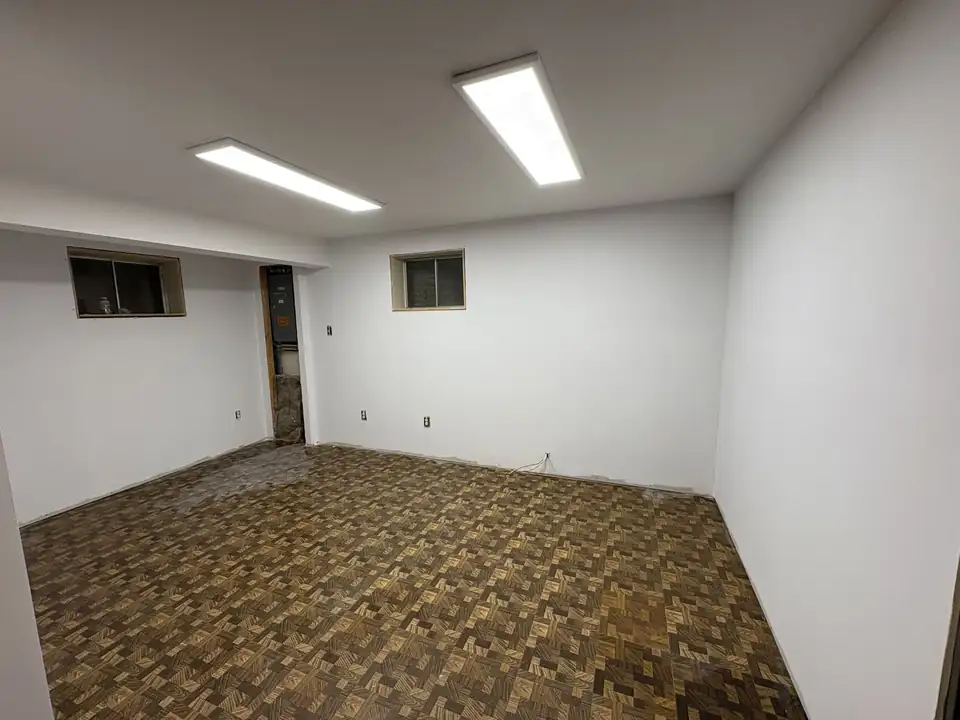 Finished basement with smooth primed white walls, part of LMG's home remodeling in Hagerstown, MD
